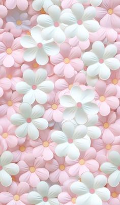 pink and white flowers are arranged in the shape of an abstract flower pattern on a wall