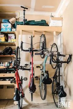 two bikes are hanging on the wall next to each other in a bike storage area