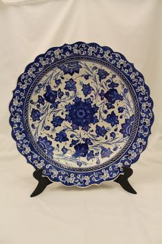 a blue and white plate with flowers on it