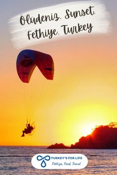 a person parasailing in the ocean at sunset with text overlay that reads quedening, sunset fethie turkey