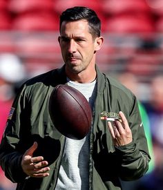 a man holding a football in his right hand