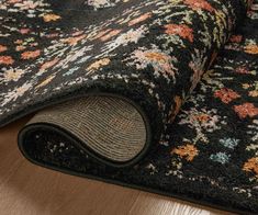 an area rug with flowers on it laying on the floor