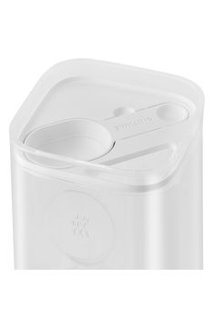 a white container with two spoons in it on a white background, the lid is empty