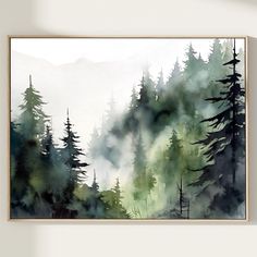 a painting hanging on the wall above a bed in front of a window with mountains and trees