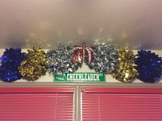 a green and white street sign hanging from the side of a wall next to red shutters