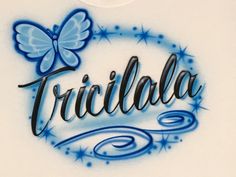 the word tricilla written in blue ink with a butterfly on it's back