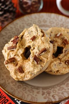 two doughnuts sitting on top of a white plate