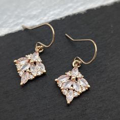 This listing is for beautiful and sparkly small cubic zirconia dangle earrings with marquise crystals in gold tone. Perfect to wear on your wedding day. rehearsal dinner or other special occasion and even makes the perfect bridesmaid gift. Material used  - Gold plated ( over brass) white crystal dangle/charm - 14k gold filled ball ear wires which are tarnish resistant and hypoallergenic - perfect for sensitive skin I have taken close up pics for you to see the details clearly. Please take note o Rose Gold Marquise Earrings For Gift, Rose Gold Marquise Earrings As Gift, Delicate Cubic Zirconia Earrings For Party, Evening Diamond Cut Cubic Zirconia Earrings, Cubic Zirconia Dangle Cluster Earrings, Gold Marquise Earrings For Party, Diamond-shaped Gold Earrings For Wedding, Dainty Crystal Earrings For Formal Events, Dainty Crystal Earrings For Formal Occasions