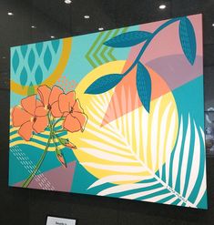 a painting on display in a building with flowers and leaves painted on the wall behind it