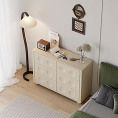 a living room with a couch, table and lamp on it's sideboard