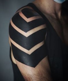 a man's arm with black and white chevroned lines on the sleeve