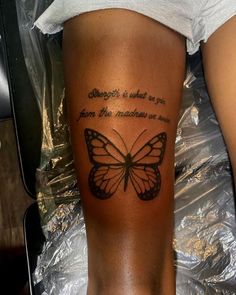 a woman's leg with a butterfly tattoo on it and the words strength is what we are from the machine we use