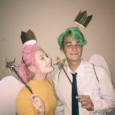 a man and woman dressed up in costumes posing for a photo with one wearing a green wig