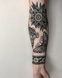 a person's arm with tattoos on it