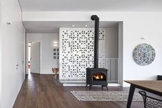 a living room with wood floors and a fire place in the middle of the room