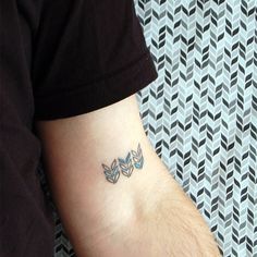 a person with a small tattoo on their arm