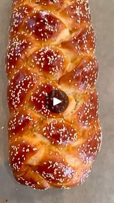 a large loaf of bread with sesame seeds on it's sides and an opening in the middle