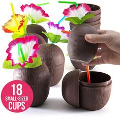 chocolate cups with flowers in them and straws sticking out of the cup's sides