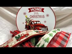 two christmas pillows sitting on top of each other next to a plate with the words home for christmas