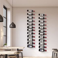 there are several wine bottles on the wall in this dining room, along with four bar stools