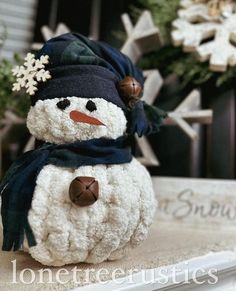 a stuffed snowman sitting on top of a table