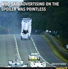 two race cars racing down a road with the caption who said advertising on the spoiler was polite