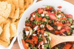 a white bowl filled with salsa and tortilla chips