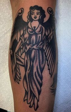 an angel tattoo on the leg