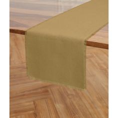 the table runner is made from linen and has a green border on top of it