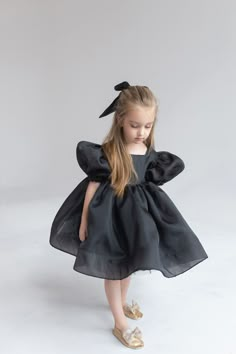 Black Organza dress Girl Baby Black girl dress First Birthday outfit Ivory Flower Girl Dress Princess dress Toddler party dress Fancy dress girl ⭐️Black Organza dress with hair bow (included)⭐️ If your little girl is having a birthday or invited to a party, this beautiful organza dress with puffy sleeves is simply essential. With this special occasion dress girls will be little fairies at any wedding, anniversary or birthday event. The black organza dress special design has been created for making your girl look really tender and awesome. ➡️To see other girl dresses https://www.etsy.com/shop/LilsBrand?ref=seller-platform-mcnav§ion_id=34367253 Size: from 6-9 months to 14 sizes Material: organza, tulle, cotton lining Making: 5-7 days Colors: black, white, ivory, blush, pink, yellow, black If Baby Black Dress Infants, Black Dress For Kids Classy, Childrens Black Dress, Classy Toddler Dress, Luxury Organza Tutu Dress For Summer, Black Party Dress For Kids, Organza Bow Dress, Fancy Kids Dresses, Flower Girl Black Dress