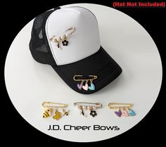 the hat is next to several earring clips and a baseball cap with charms on it