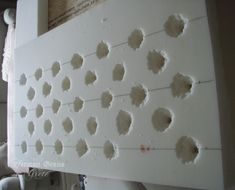 there are many holes in the wall that have been cut out to look like flowers