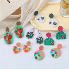 These cactus desert clay earrings are carefully crafted by me, with vibrant color combinations and delicate cactus details, they are a unique work of art and I love this work. -Polymer Clay -Handmade item -Lightweight Each pair of earrings is handmade and is uniquely yours. Perfect for nature lovers and desert dreamers, this set of 6 earrings features a charming cactus and desert flower motif, and no two earrings are alike. Bring a unique vintage summer vibe to your wardrobe, these earrings are Summer Cactus, Desert Clay, Desert Dreamer, Clay Dangle Earrings, Cactus Desert, Desert Fashion, Desert Flowers, Earrings Summer, Cactus Flowers