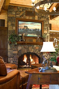 a living room filled with furniture and a fire place in front of a painting on the wall