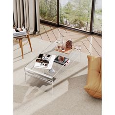 a glass coffee table sitting on top of a hard wood floor next to a window