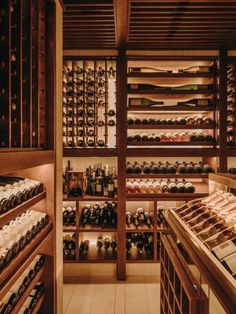 the wine cellar is filled with many bottles