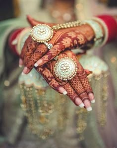 a woman's hands with hennap and jewelry