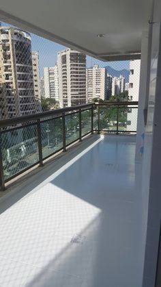 an empty balcony with city buildings in the background