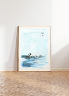 a watercolor painting of a man surfing in the ocean