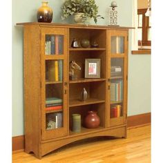 a wooden bookcase with many books on it