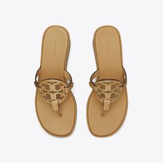 The iconic sandal with a cult following is updated with a comfortable wedge heel. Crafted in soft leather, the '90s-inspired lift offers an elevated and versatile style.Crafted in partnership with a Leather Working Group-certified tannery, supporting high standards in leather manufacturing and chemical management. Tony Burch Sandals, Tory Burch Heel Sandals, Tory Burch Rope Sandals, Tori Burch Sandals, Tory Burch Jelly Sandals, Comfortable Wedges, Tory Burch Miller, 90s Inspired, Designer Sandals