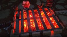 halloween decorations are lit up on the ground in front of a cemetery with tombstones and candles