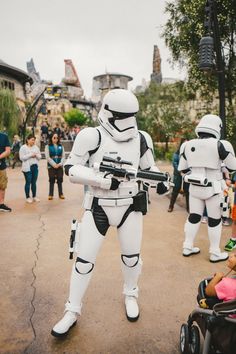 people dressed as stormtroopers are walking around