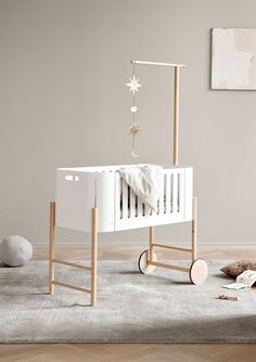 a baby crib in the middle of a room with toys on the floor and walls