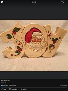 a wooden christmas ornament with a santa clause on it