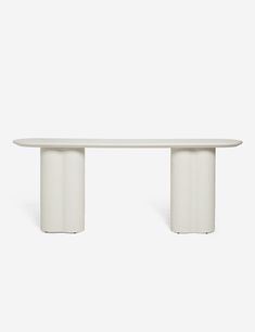 a white table sitting on top of a white floor