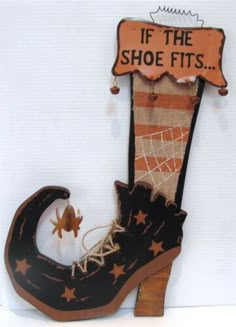 an old shoe hanging on the wall with a sign that says if the shoe fits