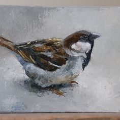 a painting of a bird sitting on top of a table