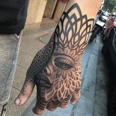 a person's hand with a tattoo on it that has an image of a woman's face