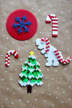 christmas decorations made out of legos and plastic beads on a table with polka dots